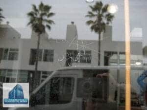 scratched glass graffiti removal -Before
