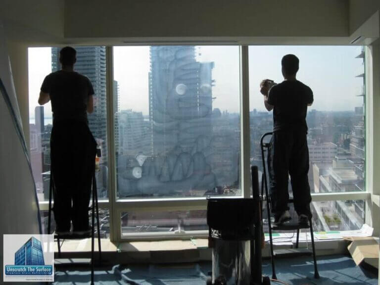 Glass Scratch Removal Toronto Canada - Commercial High-rise Rob and Adam performing tempered glass scratch removal at Shangri-La Toronto on step ladders