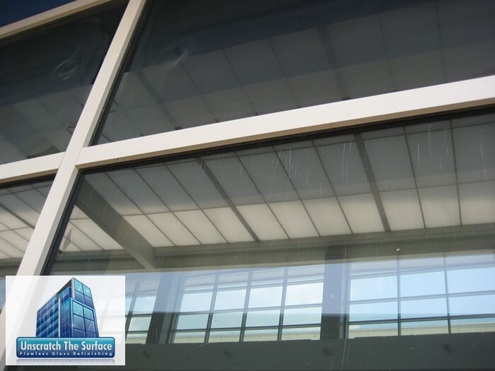 Removing deep glass scratches that are close to the edge. Notice perpendicular scratches on this hurricane glass in Biloxi, MS