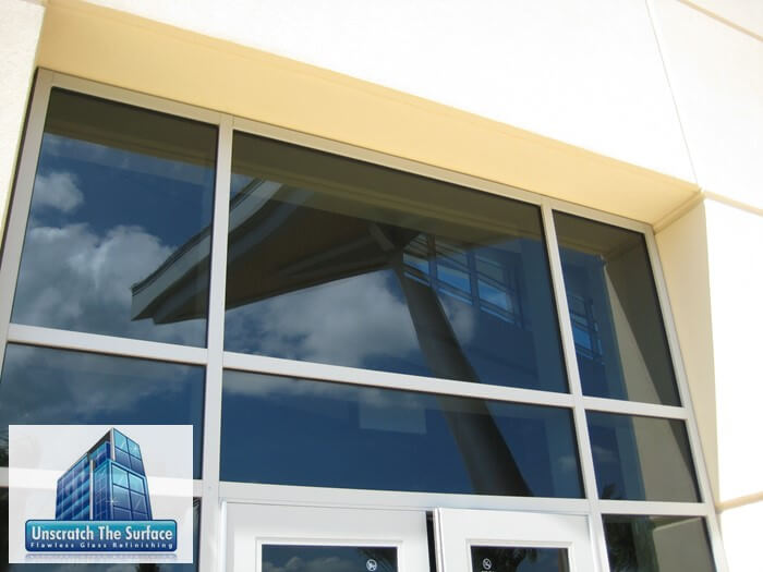 After completely polishing glass scratches, the curtain wall looks like new! Reflection shows perfectly restored windows. Project in Biloxi, MS