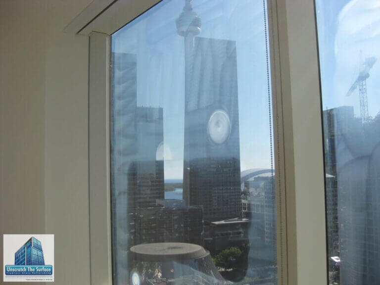 Glass Scratch Removal Toronto Canada - Commercial High-rise Commercial glass scratch removal Toronto - tempered glass half sanded half polished showing restoration progress