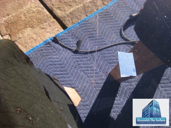 Remove Scratches from Glass Table | Bel Air CA Visible deep scratch in glass dining room table top before grinding and scratch removal. Bel Air, CA