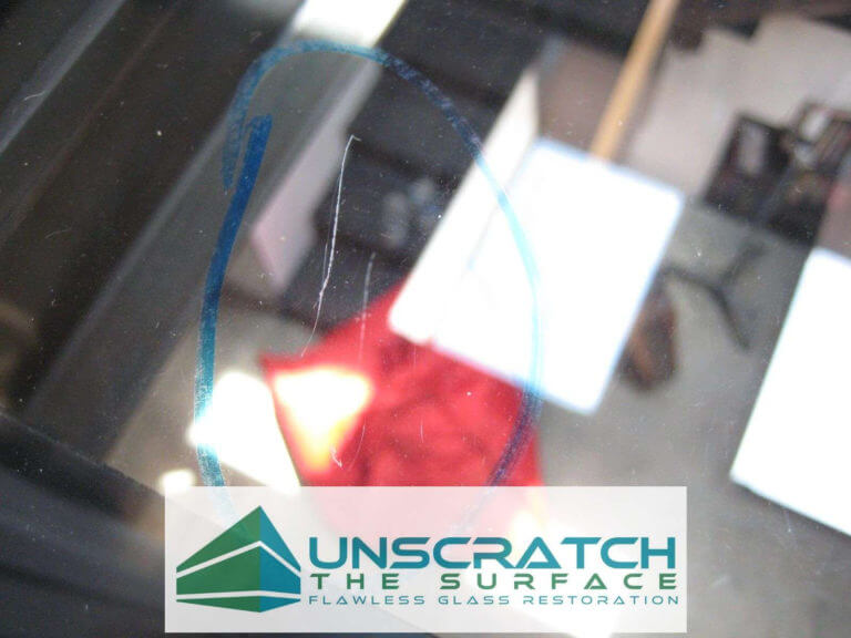 Closeup view of deep glass scratch before fixing