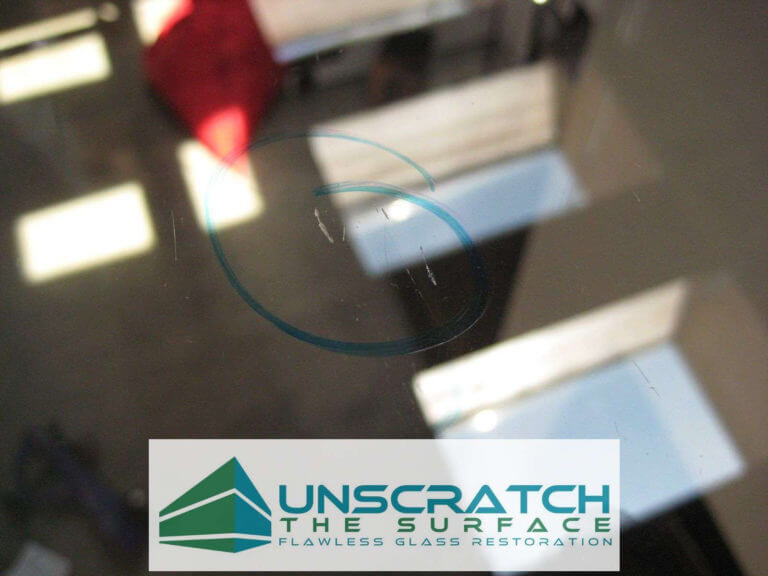 Closeup of multiple deep scratches in glass floor