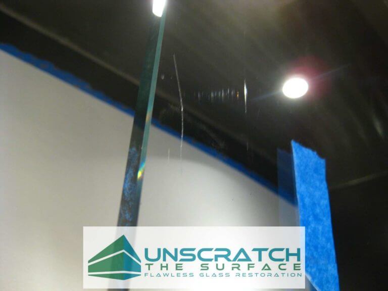 Curved Glass Scratch Removal Los Angeles CA Closeup of deep scratch in curved, tempered, glass.